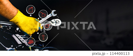 Car maintenance and servicing concept , A mechanic hand using a wrench to fix an automobile 114400113