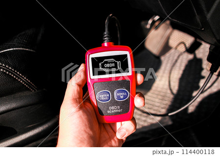 OBD scanner tool , OBD2 scanner in a car mechanic hand for car engine system analysis 114400118