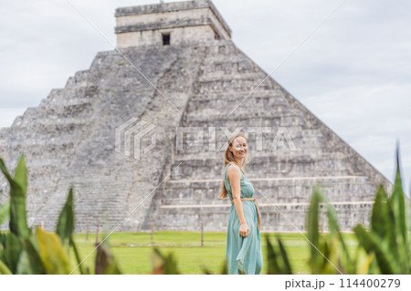 Beautiful tourist woman observing the old pyramid and temple of the castle of the Mayan architecture known as Chichen Itza these are the ruins of this ancient pre-columbian civilization and part of 114400279