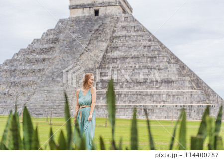 Beautiful tourist woman observing the old pyramid and temple of the castle of the Mayan architecture known as Chichen Itza these are the ruins of this ancient pre-columbian civilization and part of 114400287