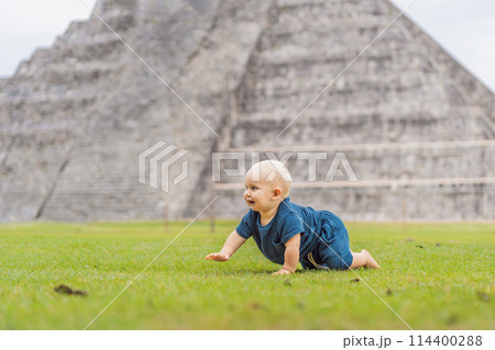 Baby traveler, tourists observing the old pyramid and temple of the castle of the Mayan architecture known as Chichen Itza these are the ruins of this ancient pre-columbian civilization and part of Baby traveler, tourists observing the old pyramid and temple of the castle of the Mayan architecture known as Chichen Itza these are the ruins of this ancient pre-columbian civilization and part of 114400288