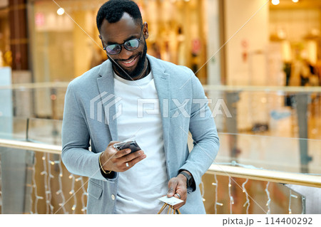excited guy looking at the screen of his smartphone excited guy looking at the screen of his smartphone 114400292