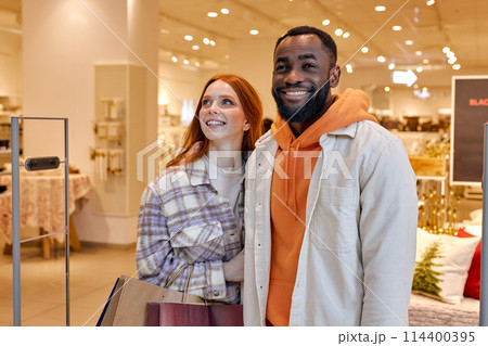 smiling positive excited couple is lucky to have found sales smiling positive excited couple is lucky to have found sales 114400395