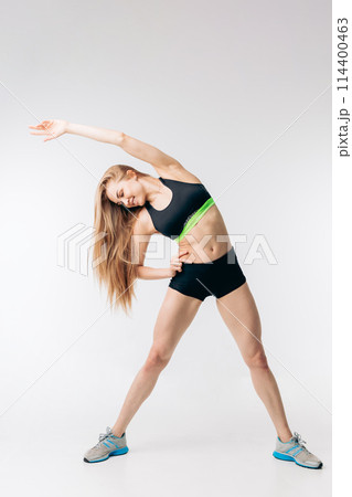 happy blond girl is doing morning exercises happy blond girl is doing morning exercises 114400463