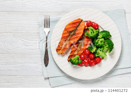 grilled salmon steaks with broccoli and tomatoes grilled salmon steaks with broccoli and tomatoes 114401272