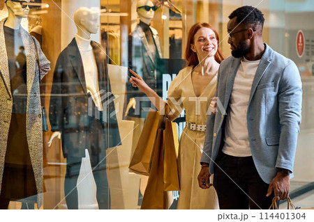 elegant happy diverse couple takes pleasure in window shopping 114401304