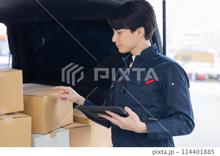 物流　タブレットで荷物を確認しているドライバー 114401885