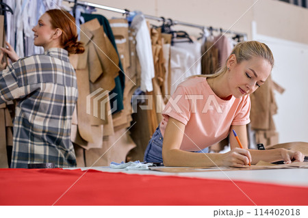 confident young fashion designer and creative partner working together in new project 114402018
