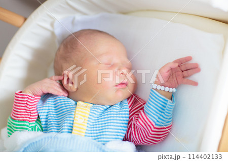 Newborn baby boy in hospital cot Newborn baby boy in hospital cot 114402133