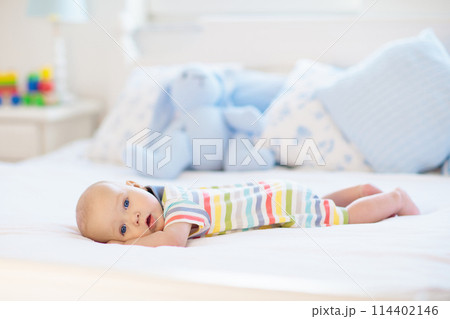 Little baby on white bed Little baby on white bed 114402146