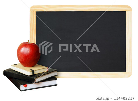 Notebooks and an apple with black chalkboard in wooden frame isolated on white 114402217