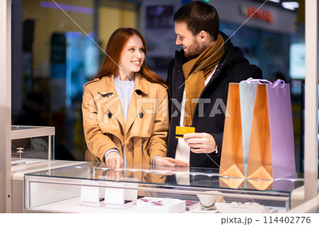 happy young romantic couple in love buy golden ring in jewelry store 114402776