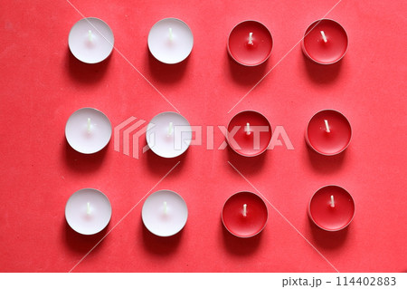 Decorative candles arranged in a row. On a pink background. 114402883