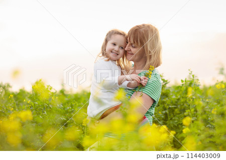 Mother and child in flower field Mother and child in flower field 114403009