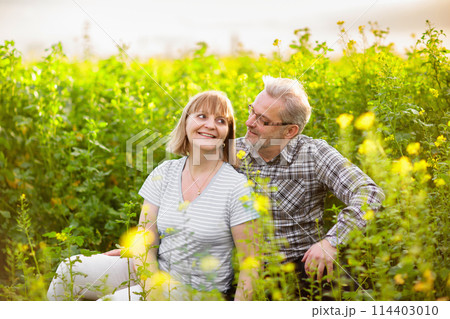 Elderly couple in blooming garden Elderly couple in blooming garden 114403010
