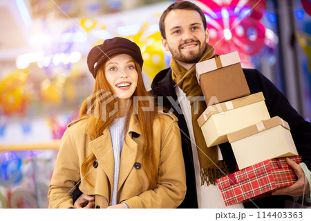 Portrait of happy couple at shopping center Portrait of happy couple at shopping center 114403363