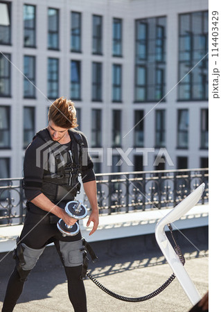handsome ambitious bodyduilder in EMS suit 114403429