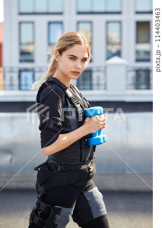 sporty girl with blue dumbbell sporty girl with blue dumbbell 114403463