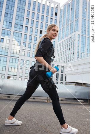 pain therapy. attractive girl is using ems costume for lossing weight pain therapy. attractive girl is using ems costume for lossing weight 114403505