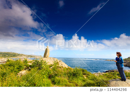 Woman tourist looking at ocean in Norway Woman tourist looking at ocean in Norway 114404298