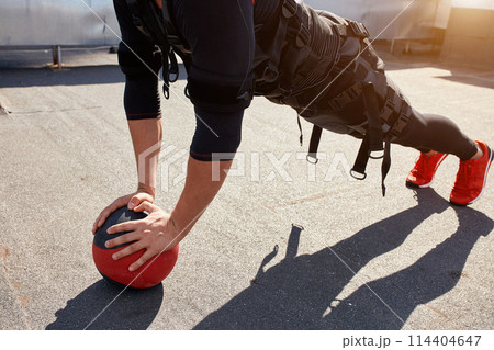close up cropped photo of a fit sporty man training with a ball 114404647