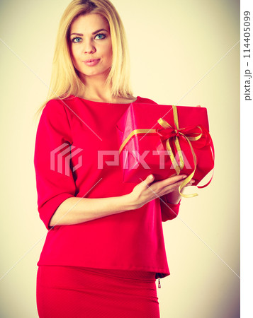 Beautiful woman with red gift. 114405099