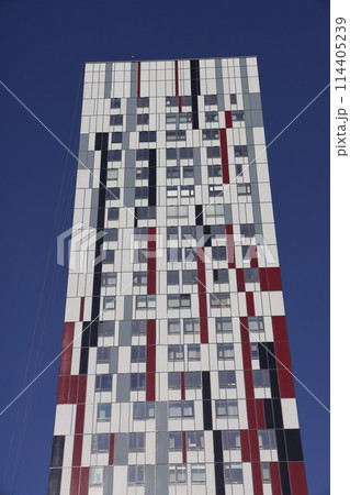 Futuristic design part of skyscrapers against a clear blue sky. Abstract facade design. 114405239