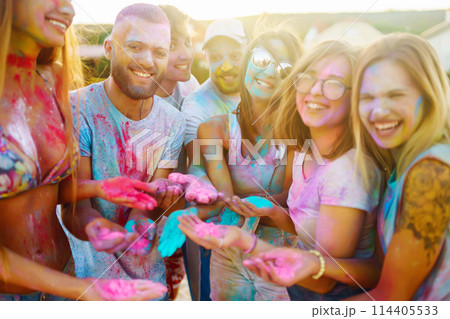 A group of friends have fun, dance at the holi festival. Celebrating traditional indian spring holiday. Friendship. 114405533