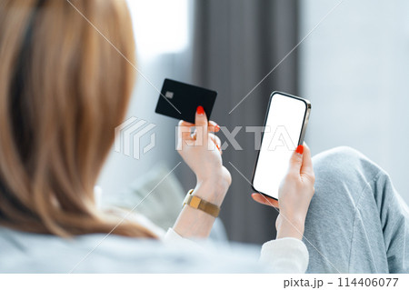 Woman Using Smartphone and Credit Card for Online Shopping Woman Using Smartphone and Credit Card for Online Shopping 114406077