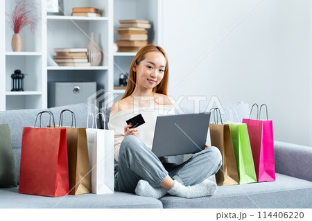 Young Woman Shopping Online With Credit Card And Laptop Young Woman Shopping Online With Credit Card And Laptop 114406220