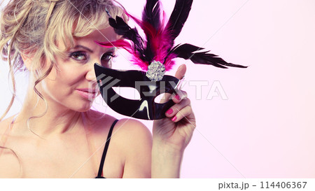 Woman middle aged holds carnival mask. Woman middle aged holds carnival mask. 114406367