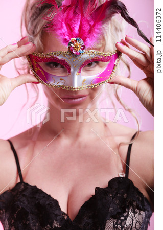 Woman middle aged holds carnival mask. 114406372