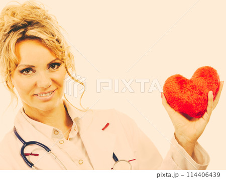 Female cardiologist with red heart. 114406439