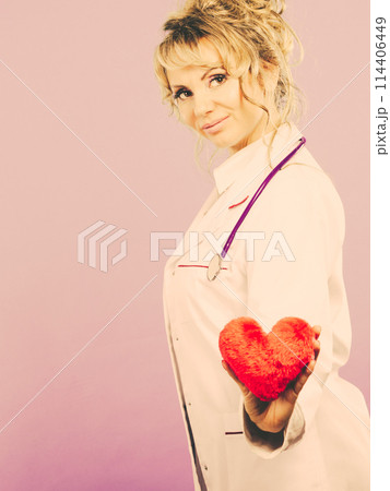 Middle aged blonde doctor enjoy her work. 114406449