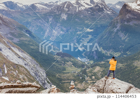 Tourist taking photo from Dalsnibba viewpoint Norway Tourist taking photo from Dalsnibba viewpoint Norway 114406453