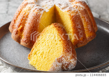 Delicious orange pound cake with zest and orange juice, sprinkled with powdered sugar on a plate. Horizontal Delicious orange pound cake with zest and orange juice, sprinkled with powdered sugar on a plate. Horizontal 114406693