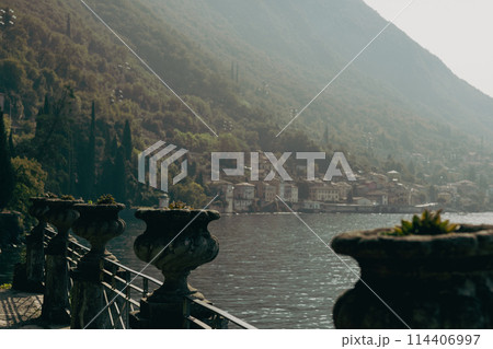 Big ornamental plant pot vase. Vases of succulent decorated with architectural elements on a sunny day. Villa Monastero, Botanical garden 114406997