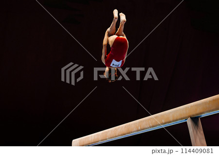 female gymnast perform backward somersault exercise on balance beam gymnastics female gymnast perform backward somersault exercise on balance beam gymnastics 114409081