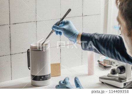 advanced equipment in a laboratory, including a microscope and a semen thaw thermostat, illustrating the innovative processes in biochemistry and biotechnology 114409358