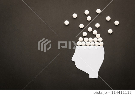 Drugs addiction and mental withdrawal symptoms concept. Human head with white pills on black background. International Day against Drug Abuse. Drugs addiction and mental withdrawal symptoms concept. Human head with white pills on black background. International Day against Drug Abuse. 114411113
