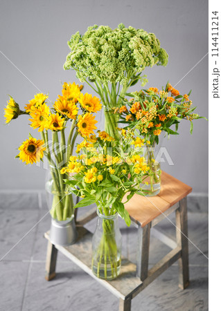 a bunch of yellow and white flowers are sitting on a table a bunch of yellow and white flowers are sitting on a table 114411214