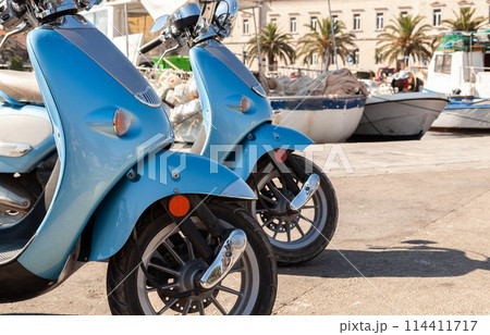 Motor Scooters Mopeds Motorbikes in a Mediterranean Fishing Village Harbor Motor Scooters Mopeds Motorbikes in a Mediterranean Fishing Village Harbor 114411717
