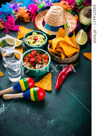 Traditional Mexican food nachos, salsa, guacamole, tequila. Traditional Mexican food nachos, salsa, guacamole, tequila. 114412669