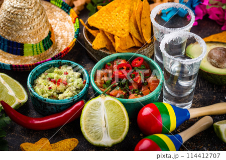 Traditional Mexican food nachos, salsa, guacamole, tequila. 114412707