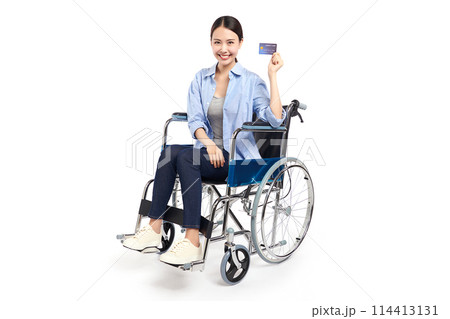 young asian women with happy smiling and show credit card sitting in a wheelchair on white background, healthcare concept, accident, insurance, life insurance, wellness, hospital. 114413131