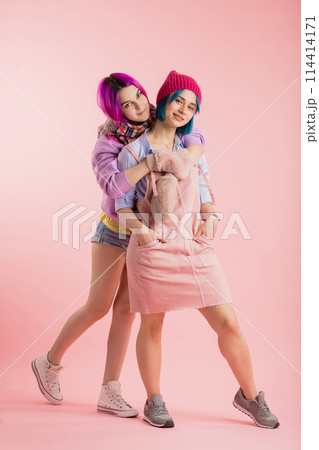 attractive girl embracing her friend attractive girl embracing her friend 114414171