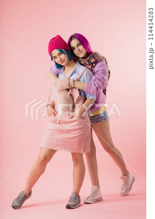 awesome stylish hipsters hugging and looking at the camera. 114414283