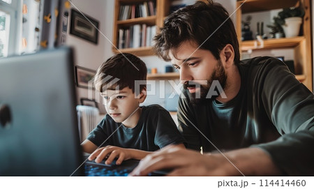 Focused Father and Son Using Laptop Together at Home. Family Bonding Over Technology. Casual Indoor Setting. Learning and Sharing Moments. AI 114414460