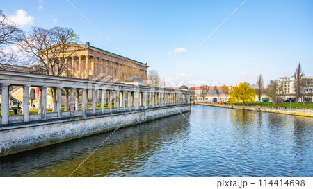 A serene view of the Old National Gallery located along the riverbank in Berlin, with classical architecture and clear skies. Germany A serene view of the Old National Gallery located along the riverbank in Berlin, with classical architecture and clear skies. Germany 114414698