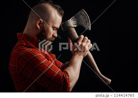 lumberjack. Confident bearded man attached to forehead axe lumberjack. Confident bearded man attached to forehead axe 114414765